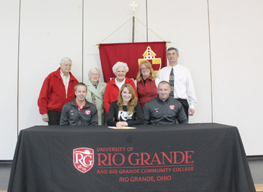 Bishop Fenwick�s Carrie Mathes poses with family and Rio Grande women�s soccer coaches Pete Masters (left) and Callum Morris 